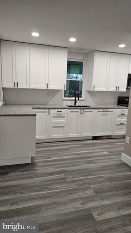 a stove top oven sitting inside of a kitchen