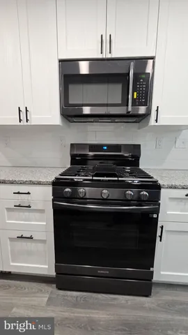 a view of kitchen and kitchen island stainless steel appliances