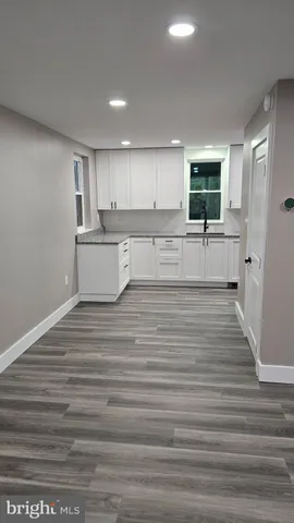 a kitchen with a refrigerator and a stove top oven