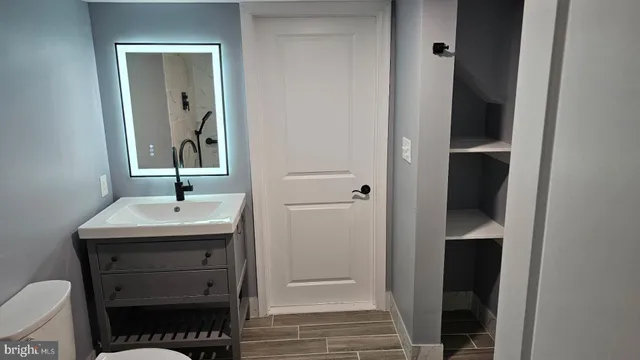 a white toilet sitting next to a bathroom sink