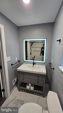 a bathroom with a white toilet and a shower