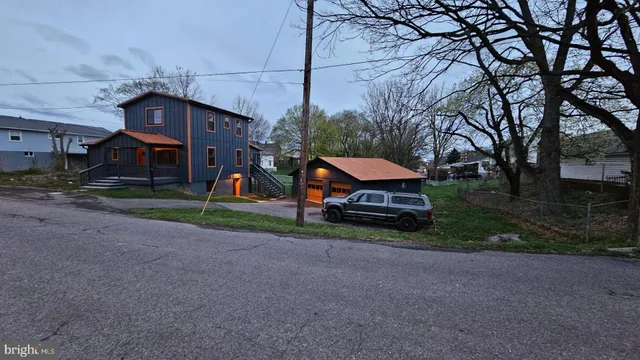 a yellow house with trees in front of it