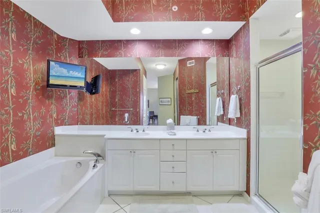 a spacious bathroom with a bathtub sink and mirror