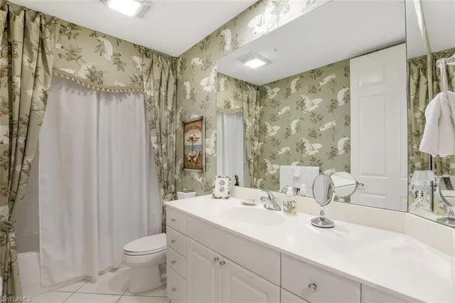 a bathroom with double vanity sink a mirror and a shower