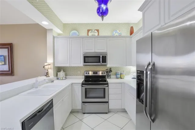 a kitchen with a sink stainless steel appliances and cabinets