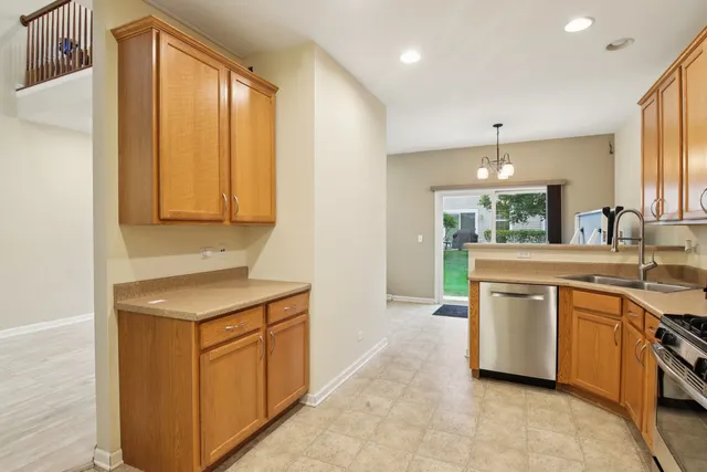 a kitchen with a sink stove and cabinets