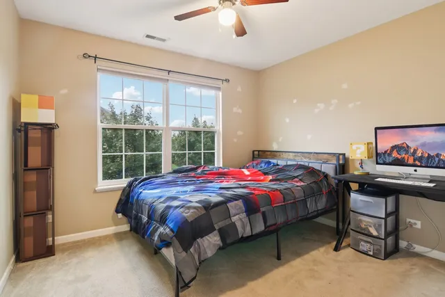 a bedroom with a bed and a chandelier