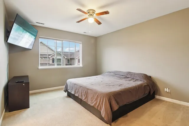 a bedroom with a bed and a painting on the wall