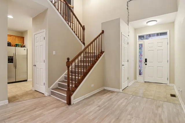 a view of a hallway with wooden floor and staircase