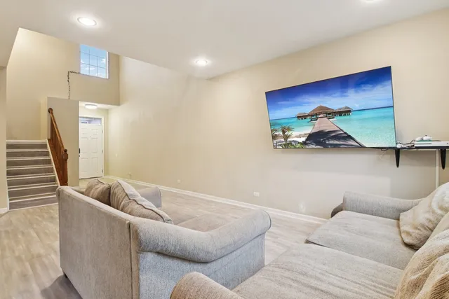 a living room with furniture and a potted plant