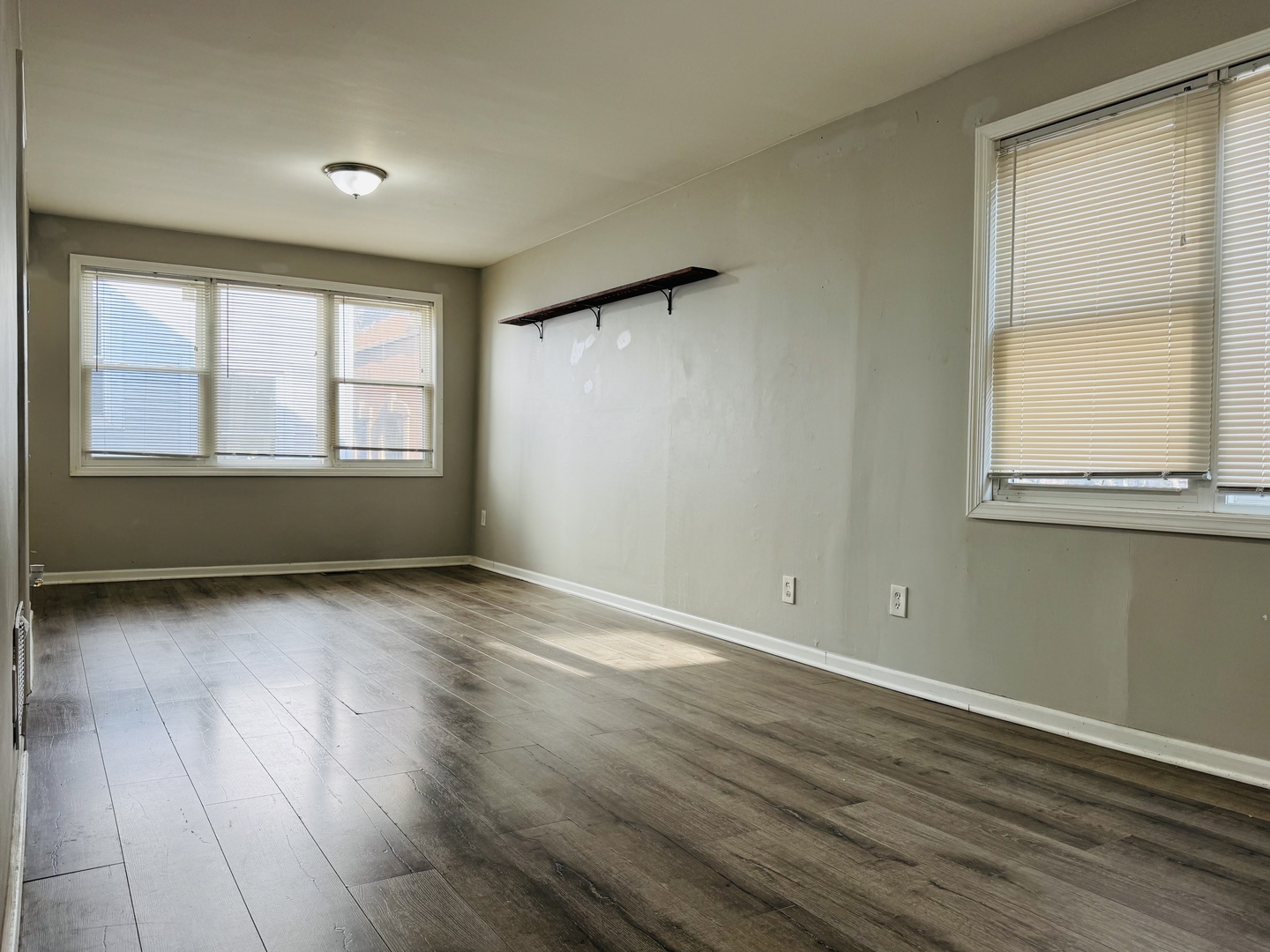 3154 South May Street Chicago, IL 60608 - Photo 2 of 2 an empty room with wooden floor and windows