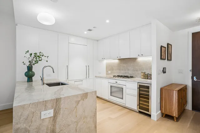 a kitchen with a sink stove and refrigerator