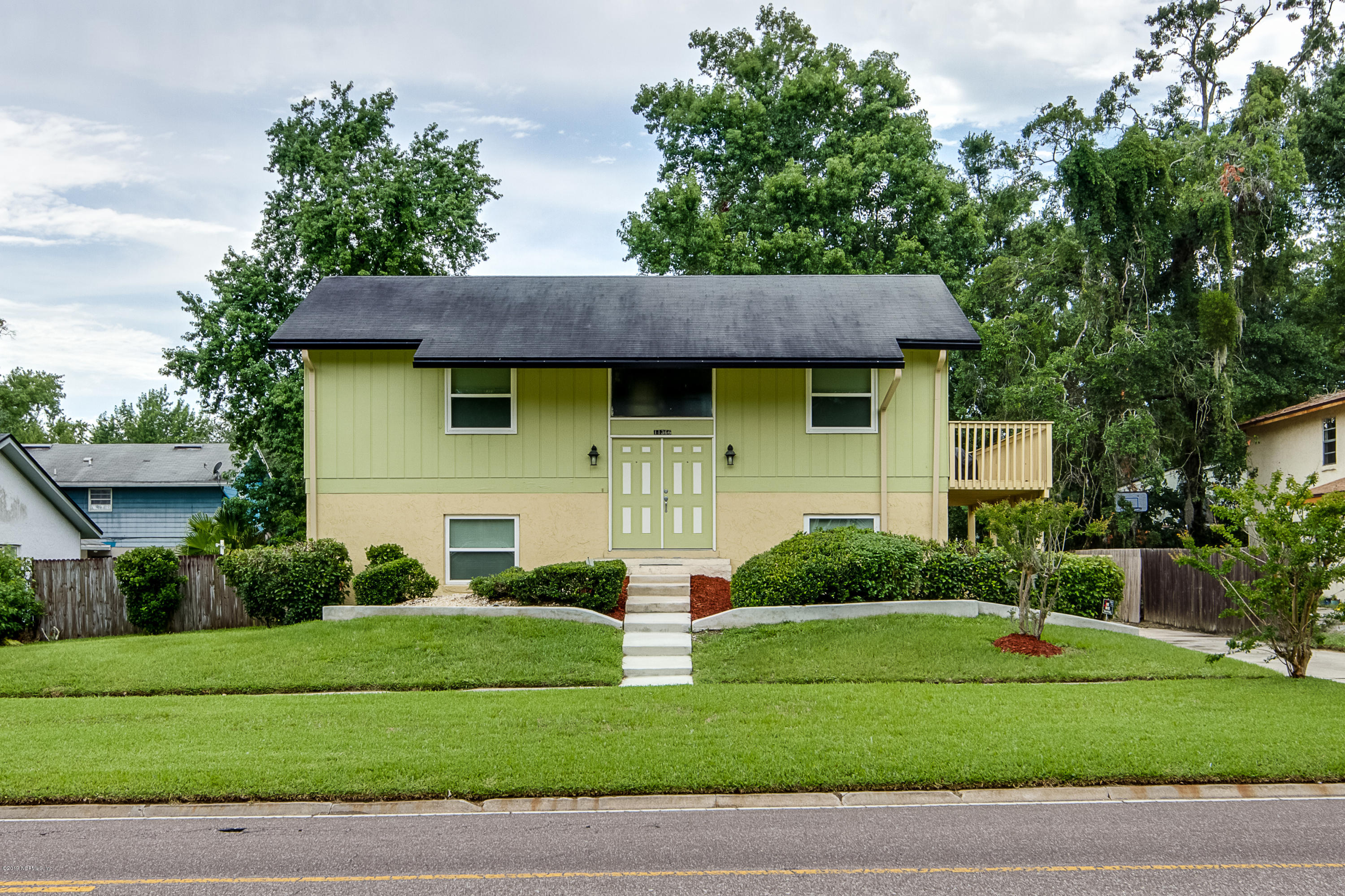 11366 Harts Road Jacksonville, FL 32218 - Photo 1 of 23 a front view of a house with a garden