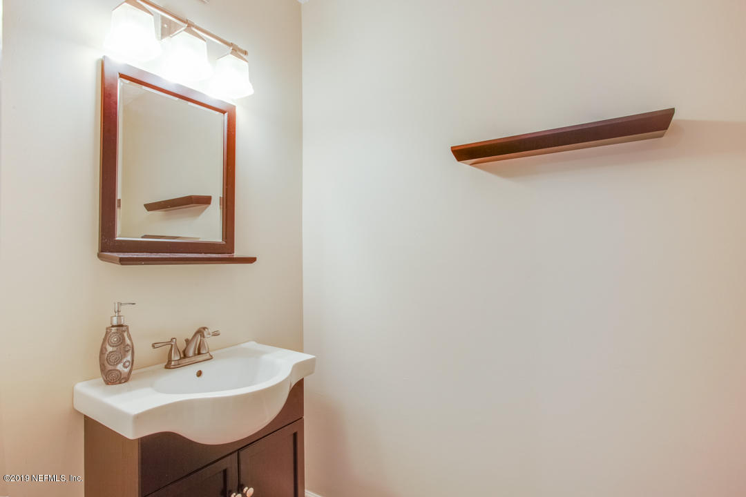 11366 Harts Road Jacksonville, FL 32218 - Photo 15 of 23 a bathroom with a sink and a mirror