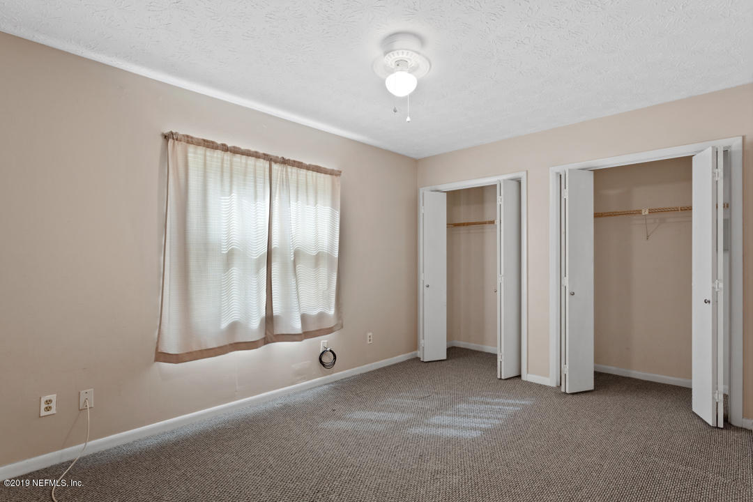 11366 Harts Road Jacksonville, FL 32218 - Photo 16 of 23 an empty room with windows and closet