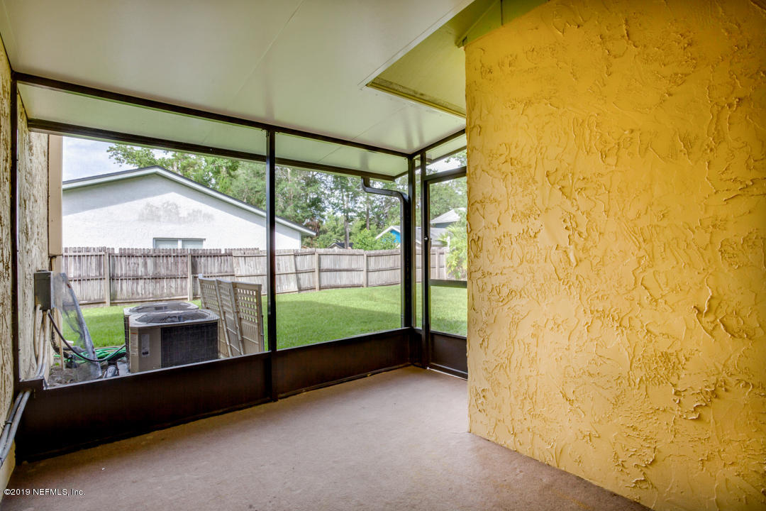 11366 Harts Road Jacksonville, FL 32218 - Photo 19 of 23 a view of porch with a table and chairs