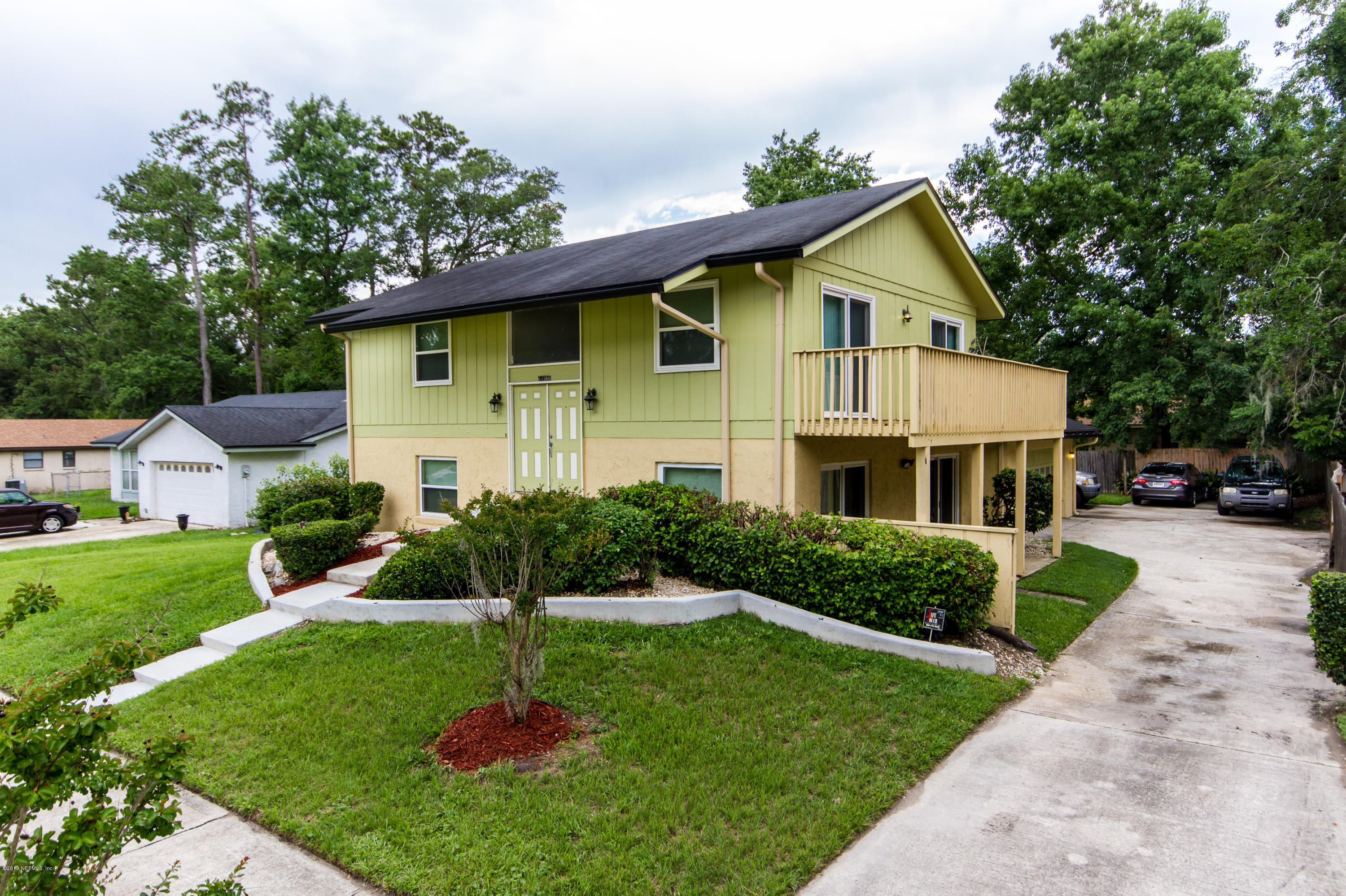11366 Harts Road Jacksonville, FL 32218 - Photo 2 of 23 a front view of a house with a yard and trees