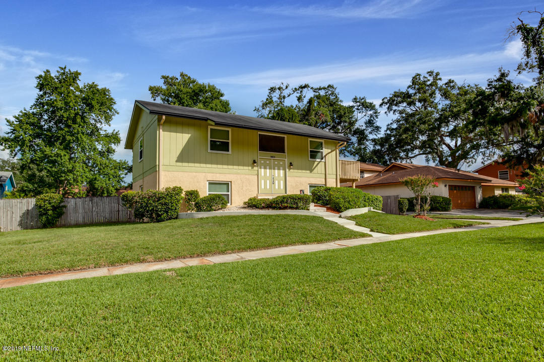 11366 Harts Road Jacksonville, FL 32218 - Photo 3 of 23 a front view of a house with a yard