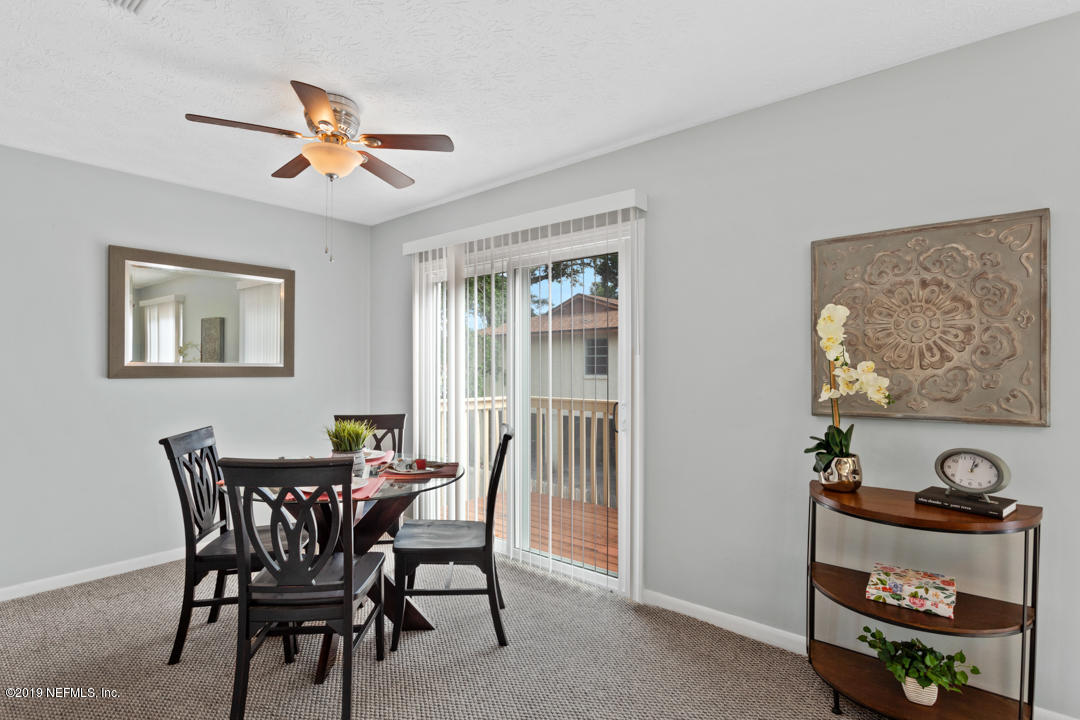 11366 Harts Road Jacksonville, FL 32218 - Photo 8 of 23 a view of a dining room with furniture and a chandelier
