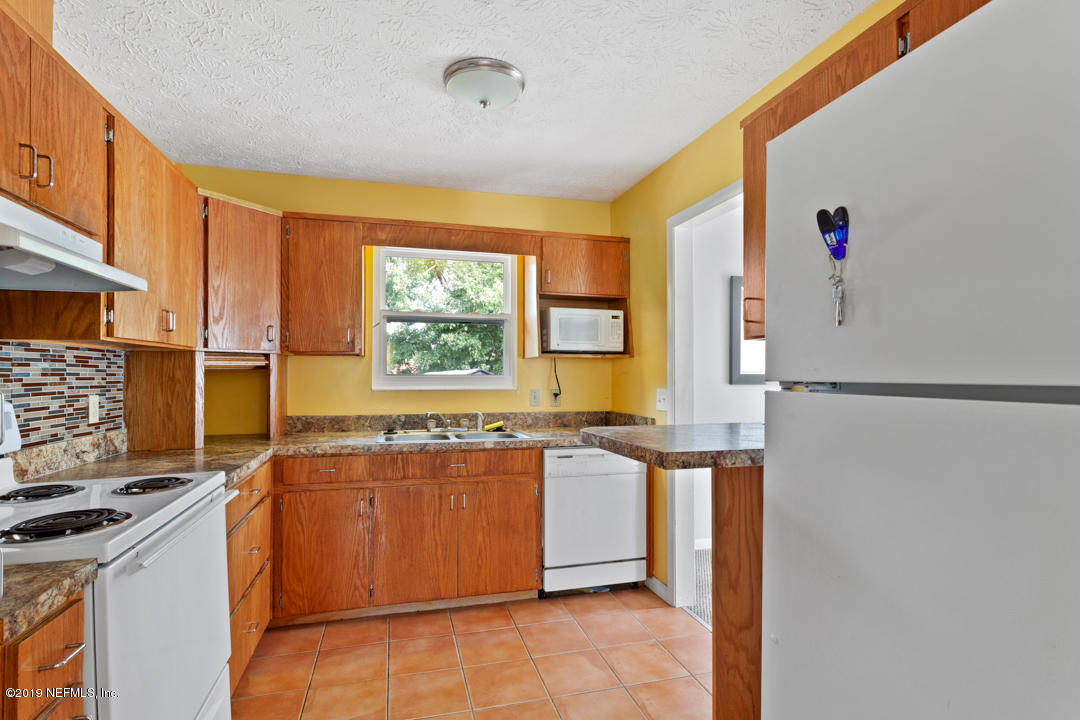 11366 Harts Road Jacksonville, FL 32218 - Photo 9 of 23 a kitchen with stainless steel appliances granite countertop a stove a sink and a refrigerator