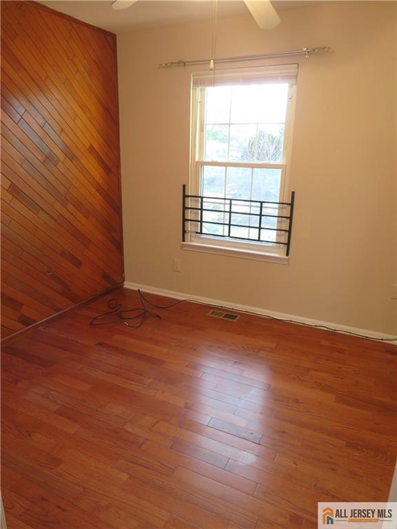 601 Maplecrest Road Edison, NJ 08820 - Photo 15 of 27 an empty room with wooden floor and windows