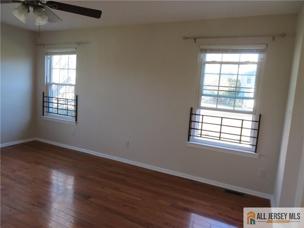 601 Maplecrest Road Edison, NJ 08820 - Photo 22 of 27 a view of an empty room with a window and wooden floor