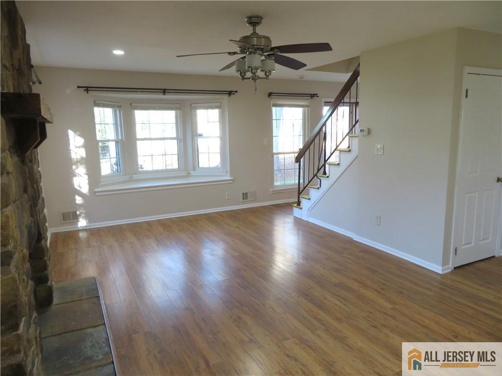 601 Maplecrest Road Edison, NJ 08820 - Photo 3 of 27 a view of an empty room with wooden floor and a window