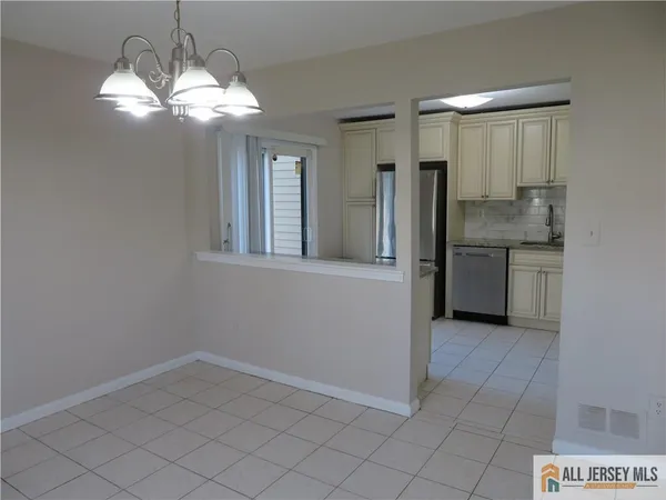a view of entryway and kitchen
