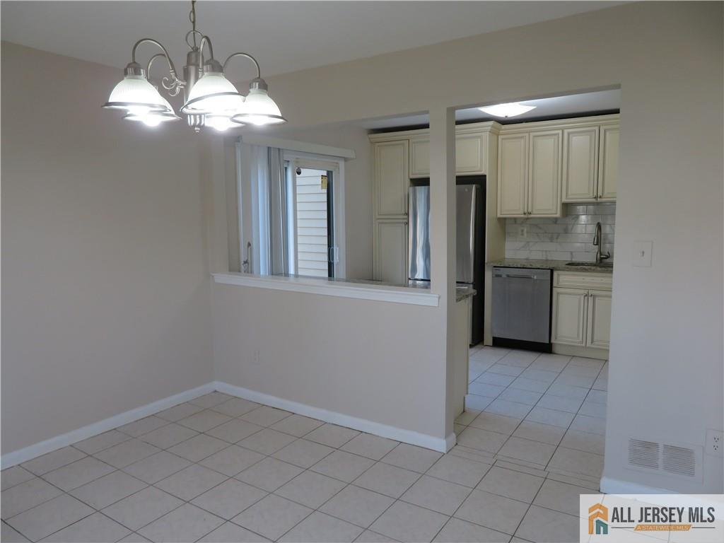 601 Maplecrest Road Edison, NJ 08820 - Photo 5 of 27 a view of a kitchen cabinets and chandelier