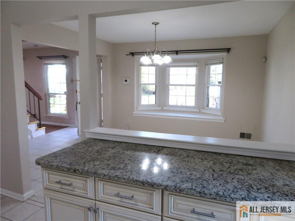 601 Maplecrest Road Edison, NJ 08820 - Photo 7 of 27 a view of a kitchen with granite countertop cabinets and wooden floor
