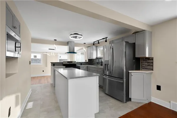 a kitchen with a refrigerator a sink and a stove