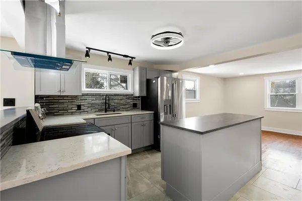 a kitchen with stainless steel appliances granite countertop a sink stove and refrigerator
