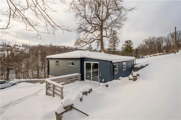 a view of a house with a snow in the yard