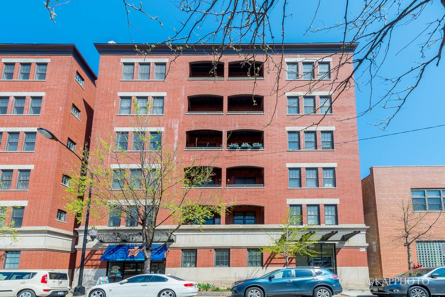 1148 West Monroe Street, Unit 6SW Chicago, IL 60607 - Photo 1 of 15 a front view of a building with glass windows