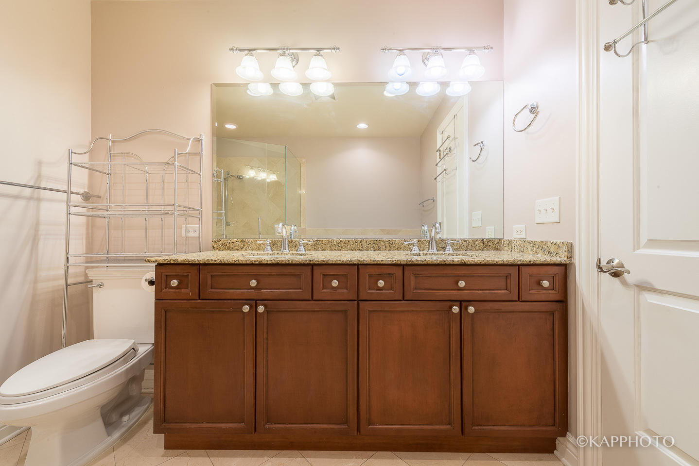 1148 West Monroe Street, Unit 6SW Chicago, IL 60607 - Photo 12 of 15 a bathroom with a granite countertop sink a toilet and a mirror