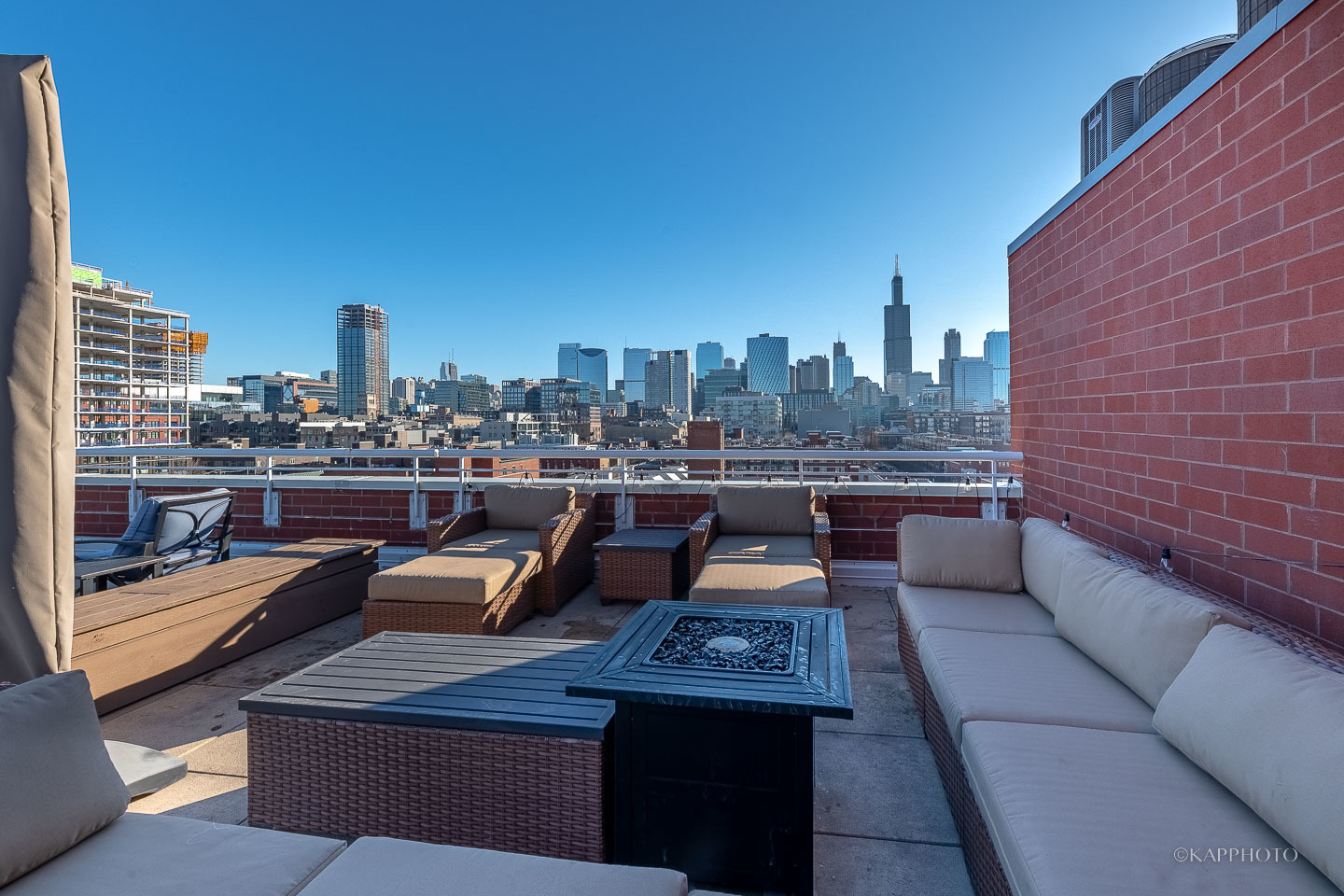 1148 West Monroe Street, Unit 6SW Chicago, IL 60607 - Photo 15 of 15 a view of a rooftop deck with couch and chairs