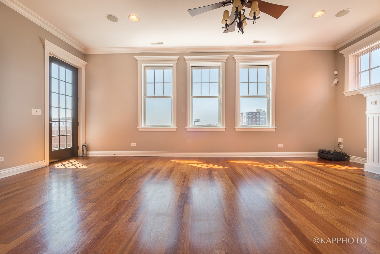 1148 West Monroe Street, Unit 6SW Chicago, IL 60607 - Photo 6 of 15 a view of an empty room with wooden floor and a window