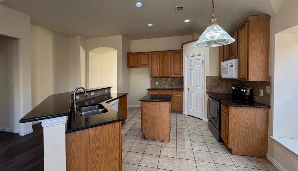 405 Colony Drive Allen, TX 75013 - Photo 13 of 17 a kitchen with a sink a counter top space appliances and cabinets