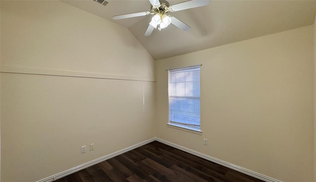 405 Colony Drive Allen, TX 75013 - Photo 15 of 17 an empty room with chandelier fan and windows
