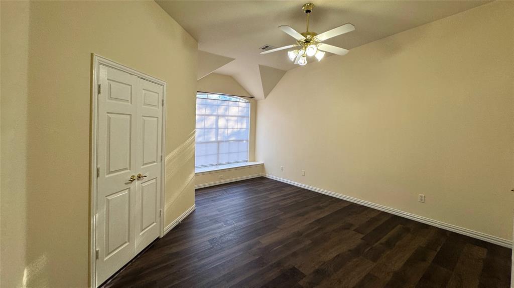 405 Colony Drive Allen, TX 75013 - Photo 7 of 17 an empty room with wooden floor and fan