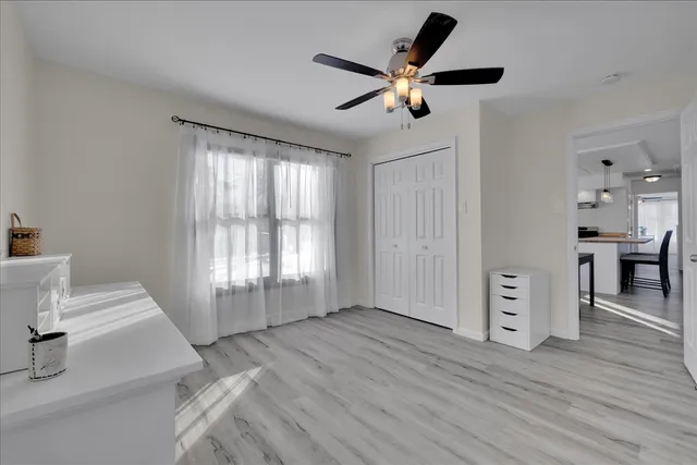 a view of a livingroom with a furniture wooden floor and a window