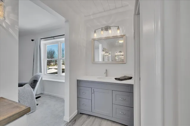 a bathroom with a granite countertop sink and mirror