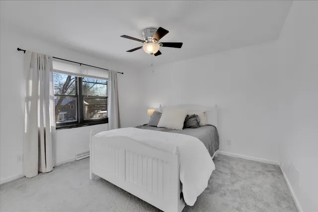 a bedroom with a bed and window