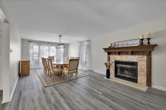 a dining room with furniture and wooden floor