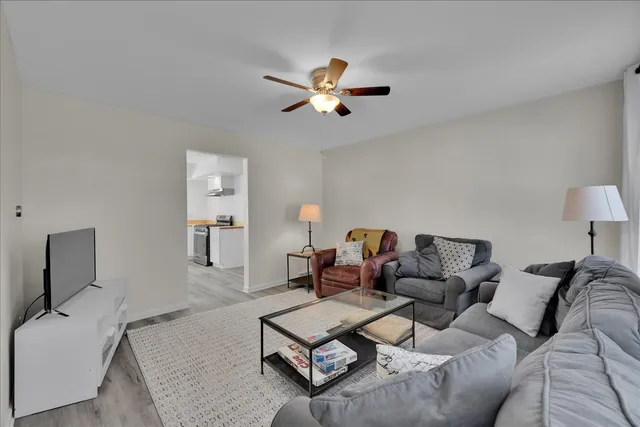 a living room with furniture and a wooden floor