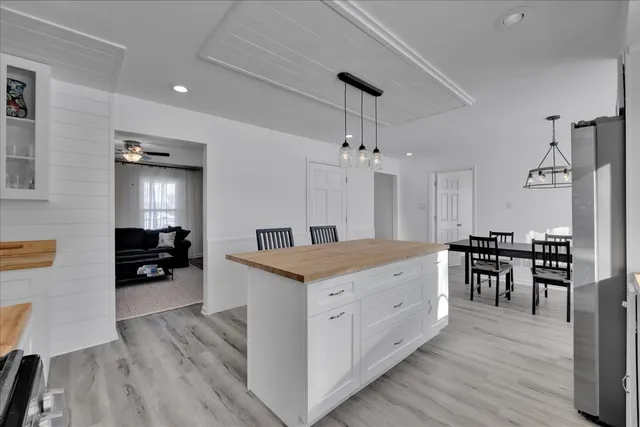 a kitchen with granite countertop counter space dining table and wooden floor