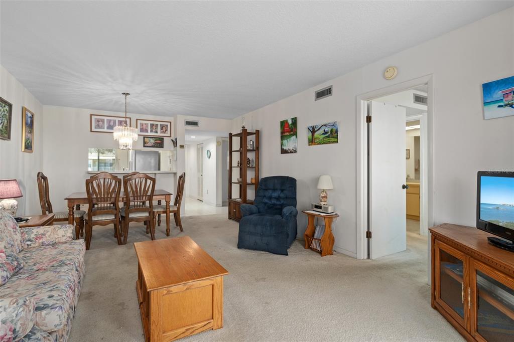 8211 Brent Street, Unit 816 Port Richey, FL 34668 - Photo 13 of 52 a living room with furniture and a flat screen tv