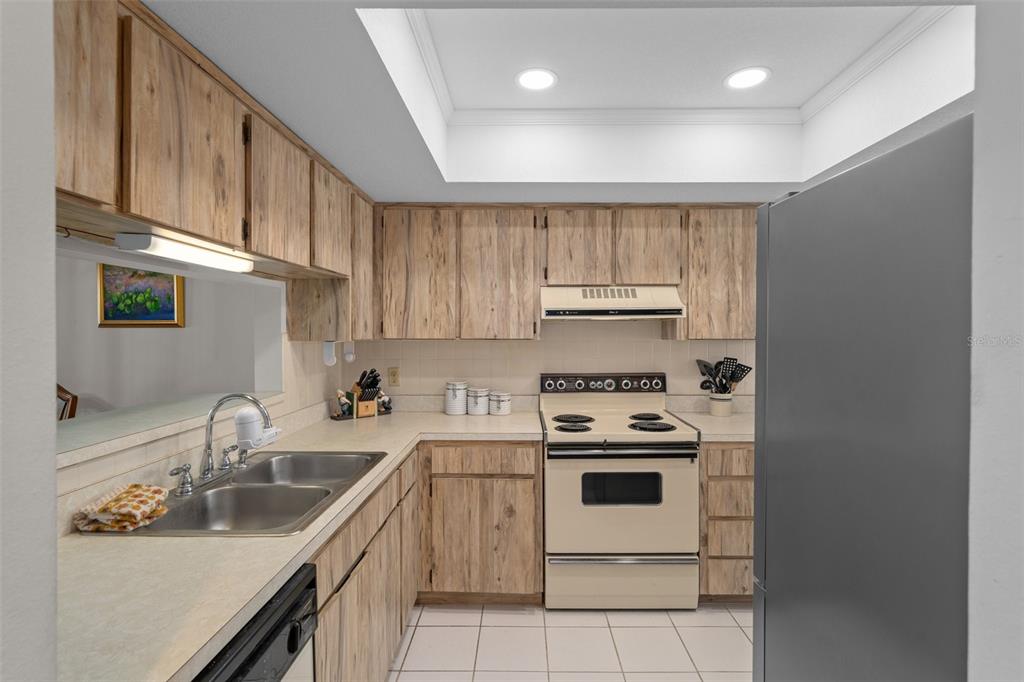 8211 Brent Street, Unit 816 Port Richey, FL 34668 - Photo 16 of 52 a kitchen with a sink stove and cabinets