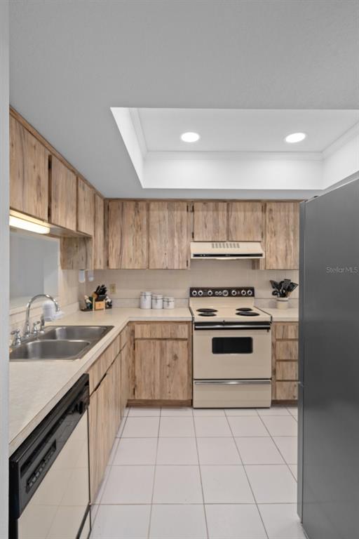 8211 Brent Street, Unit 816 Port Richey, FL 34668 - Photo 21 of 52 a kitchen with a stove sink and cabinets