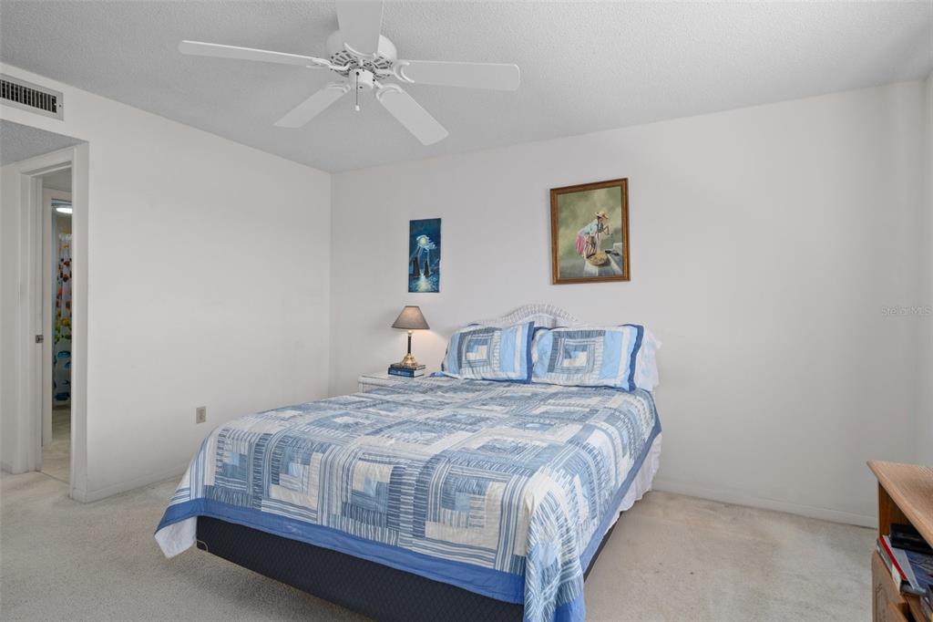 8211 Brent Street, Unit 816 Port Richey, FL 34668 - Photo 23 of 52 a bedroom with a bed and a wall painting